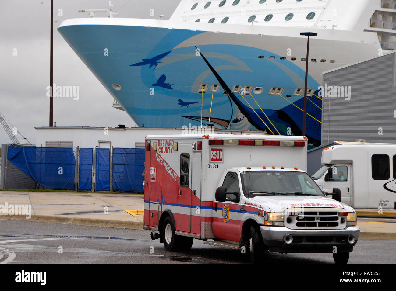 Port Canaveral, Florida, USA. März 5, 2019. Norwegian Cruise Lines "Escape" kommt am Hafen Canaveral nach mehreren Passagieren auf See wurden verletzt. Die "Flucht" auf 115 MPH Winden, nachdem sie aus New York auf dem Weg nach Florida fuhren. Das Schiff war unbeschädigt und Sie nächsten Anlaufhafen fortsetzen. Mehr als 15 Einsatzfahrzeuge von Canaveral Feuerwehr und Brevard County Fire Rescue eingetragen am Kai, wie das Schiff angedockt wurde. Verletzte Passagiere wurden mit lokalen Krankenhäusern für die Behandlung und Auswertung transportiert. Foto Julian Porree/Alamy leben Nachrichten Stockfoto