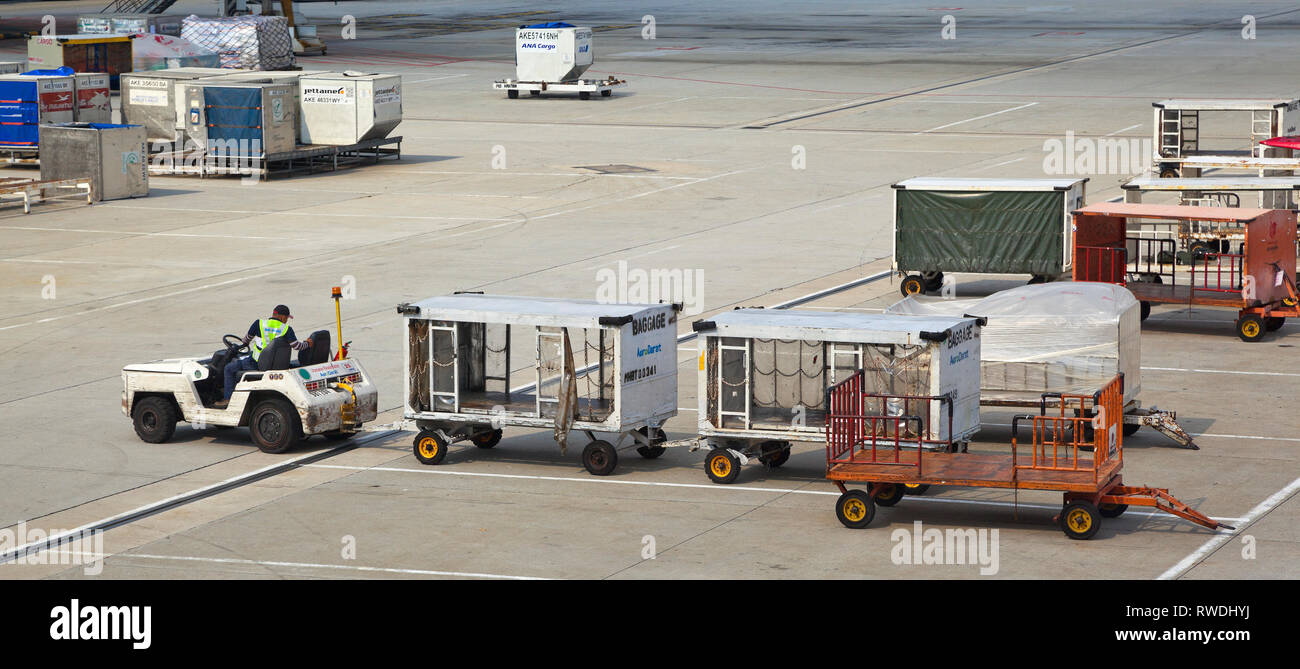 Flughafen Szene mit Flugzeugen und Support Fahrzeuge, Gepäck loader, helle Sonne. Stockfoto