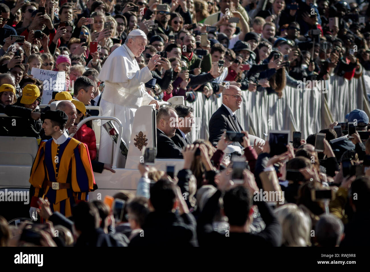 Papst Franziskus gesehen Reiten auf der Papst-mobile durch die Menge der Gläubigen, wie er kommt, um die Generalaudienz auf dem Petersplatz zu führen. Das allgemeine Publikum ist jeden Mittwoch, wenn der Papst im Vatikan in Saint Peter's Square, in dem rund 80.000 Personen statt. Bei der Generalaudienz, auch genannt die Päpstliche Audienz des Heiligen Vaters Adressen der Masse in verschiedenen Sprachen. Stockfoto