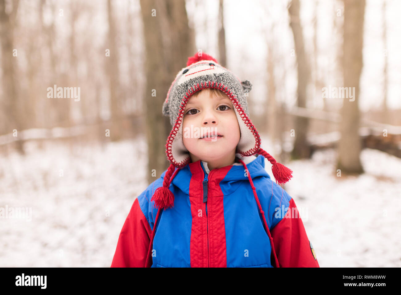 Junge in Strick Hut von verschneiten Wald, Porträt Stockfoto