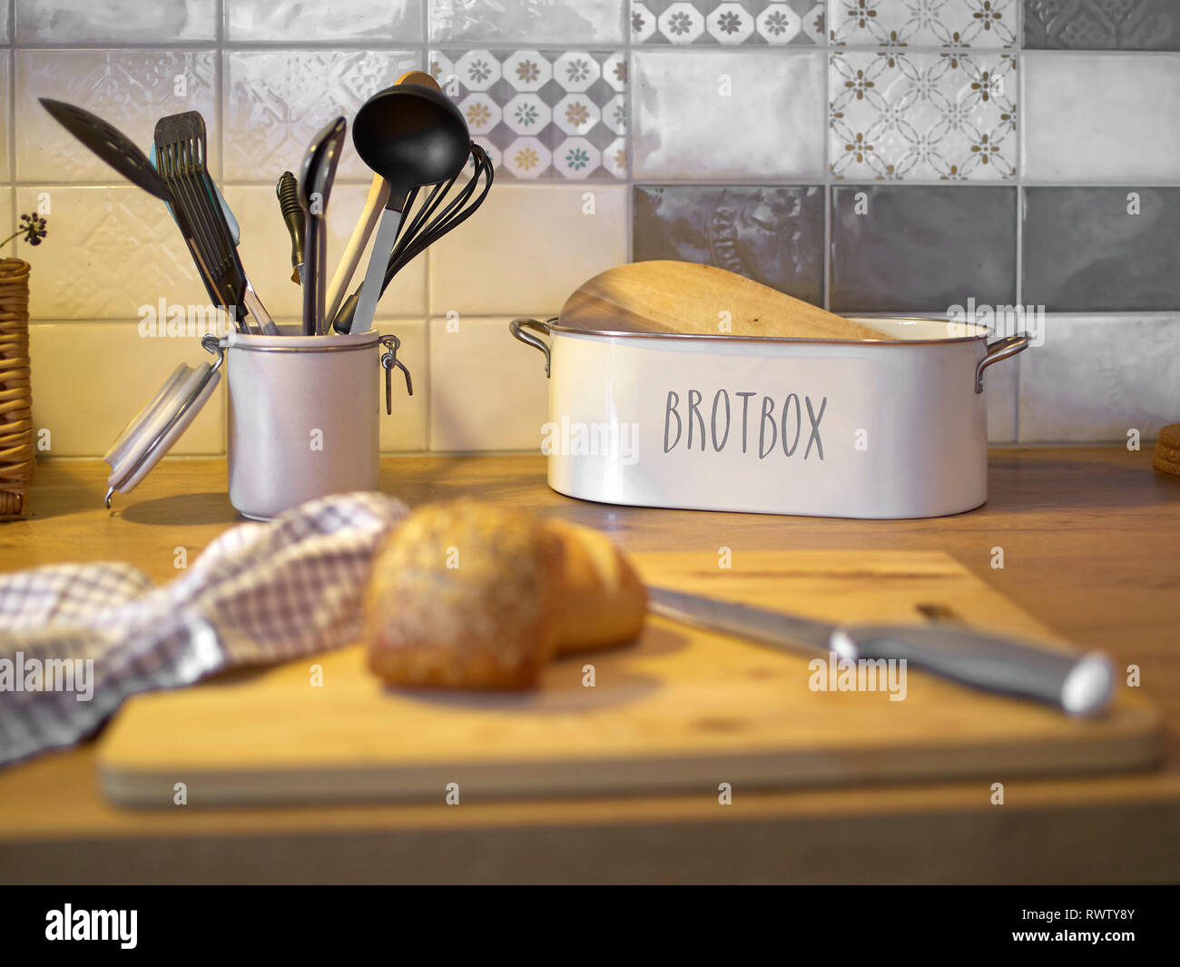 Brot und verschiedenen Küche Tools auf einem Küchentisch mit Rollen im Vordergrund. Stockfoto