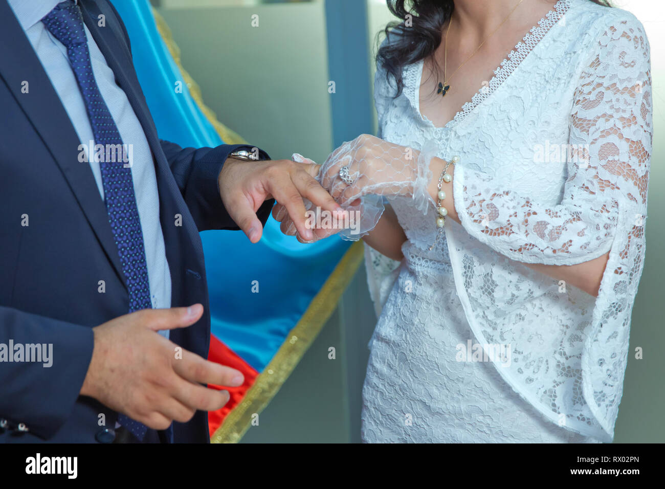 Traditionelle Trauung in der Kirche. Der Priester ist, goldenen Ring am Finger des Bräutigams. Happy Hochzeit paar auf Ihrer Feier. Stockfoto