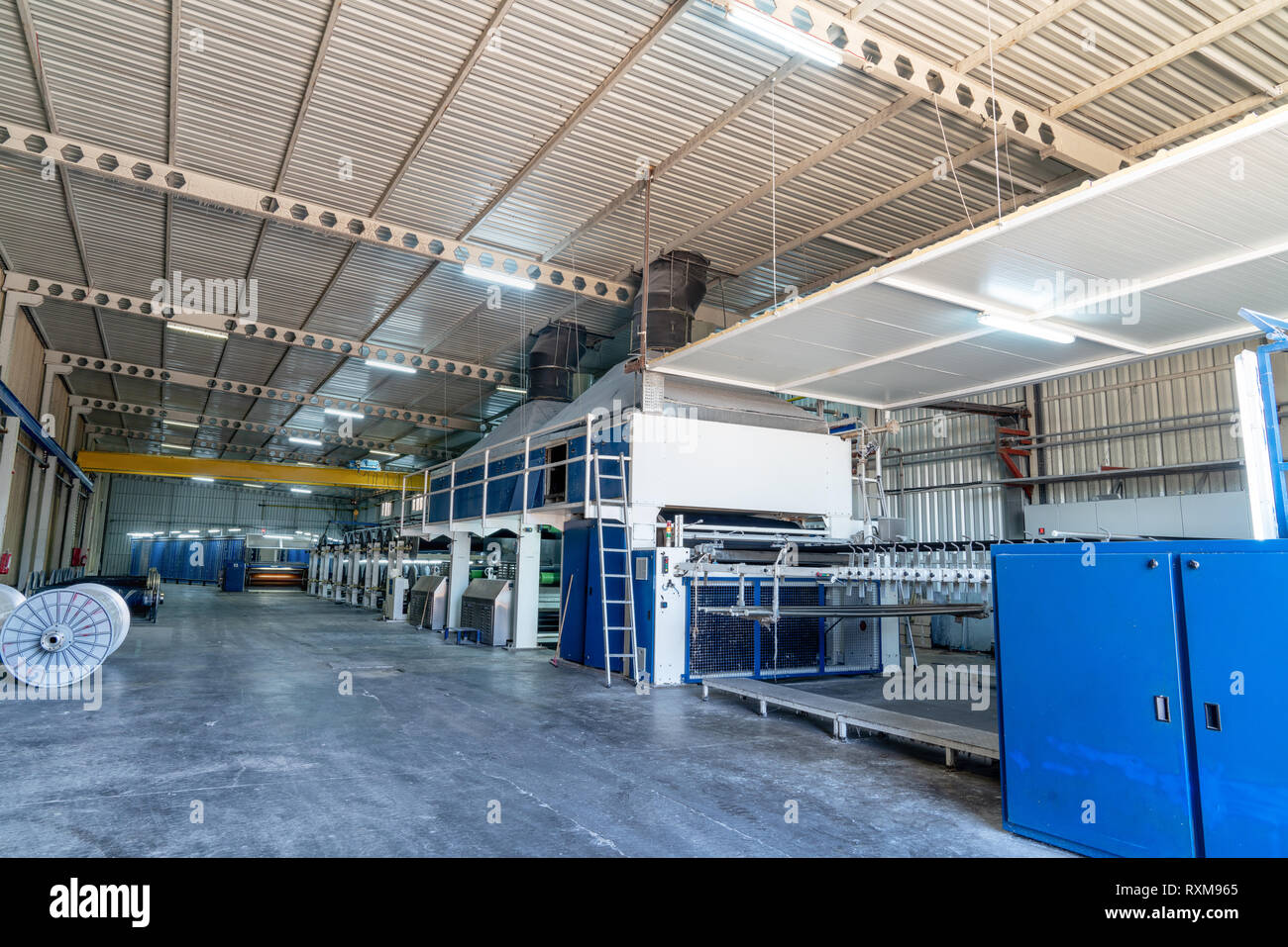 Innenraum der Textilfabrik mit automatischen Maschinen. Konzept der Industrie und Technologie Stockfoto