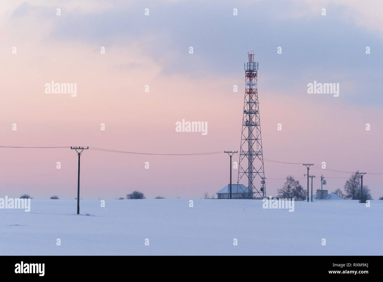 Fernmeldeturm im Winter, Fernmeldeturm mit Mobilfunk-Antenne und Satellitenschüssel Stockfoto