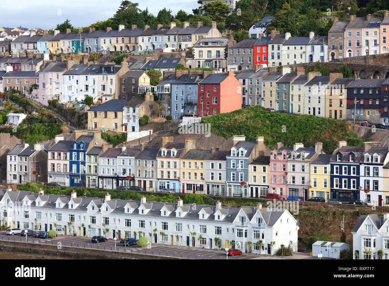 Lange Reihe von Reihenhäuser gestapelt übereinander auf einem Hügel in Cobh, Irland Stockfoto