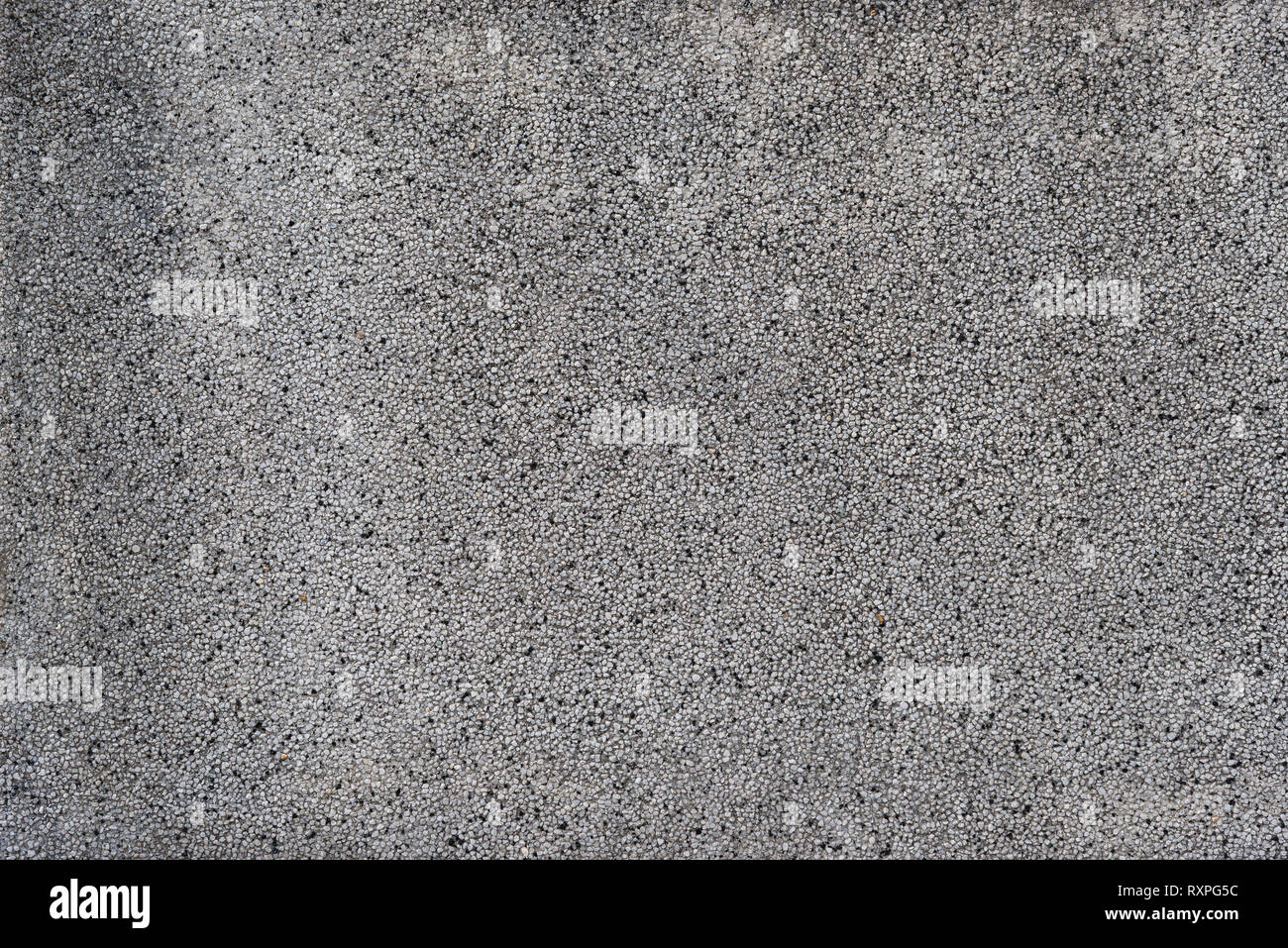 Grauer Beton mit Kies Wand rauen Oberfläche, als Hintergrund Stockfoto