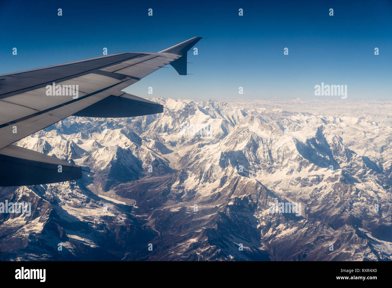 Luftaufnahme der schneebedeckten Himalaya Berg in Nepal von einer Ebene an einem sonnigen Tag Stockfoto