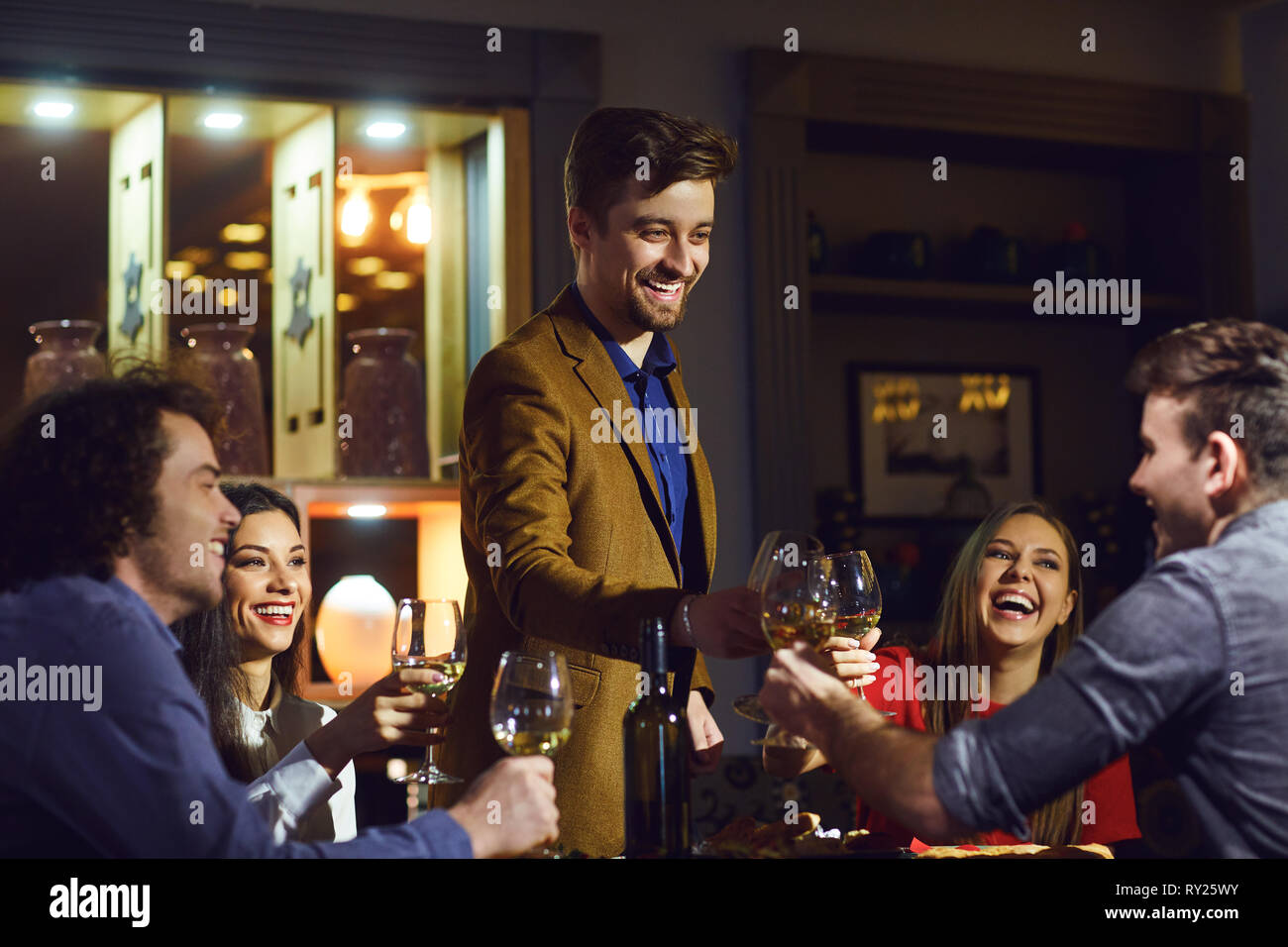 Freunde lachen, essen, trinken, in ein Restaurant zum Abendessen Stockfoto