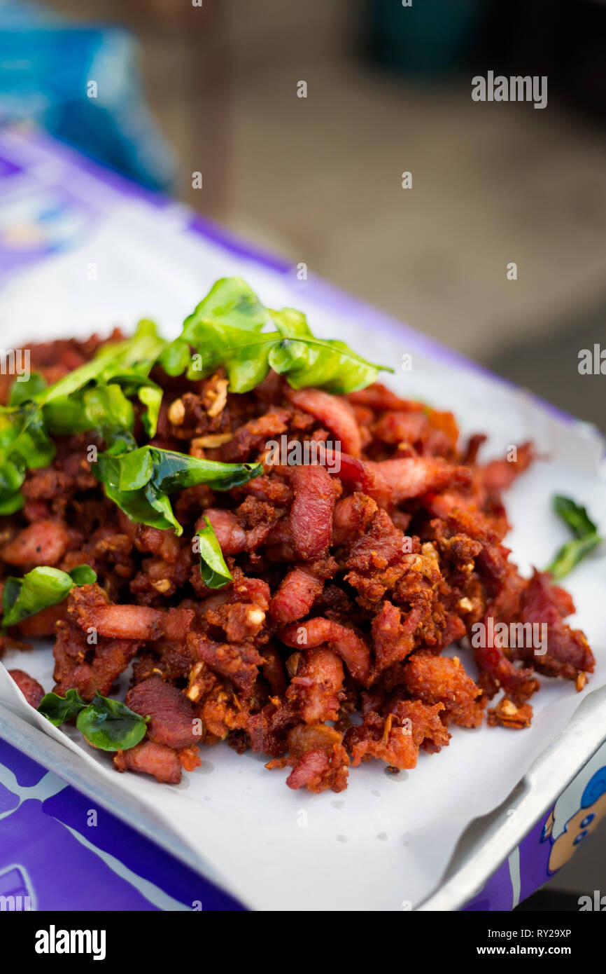 Thai gebratene rote Schweinefleisch mit kaffernlimette Blätter serviert. Traditionelle südostasiatische Küche. Stockfoto