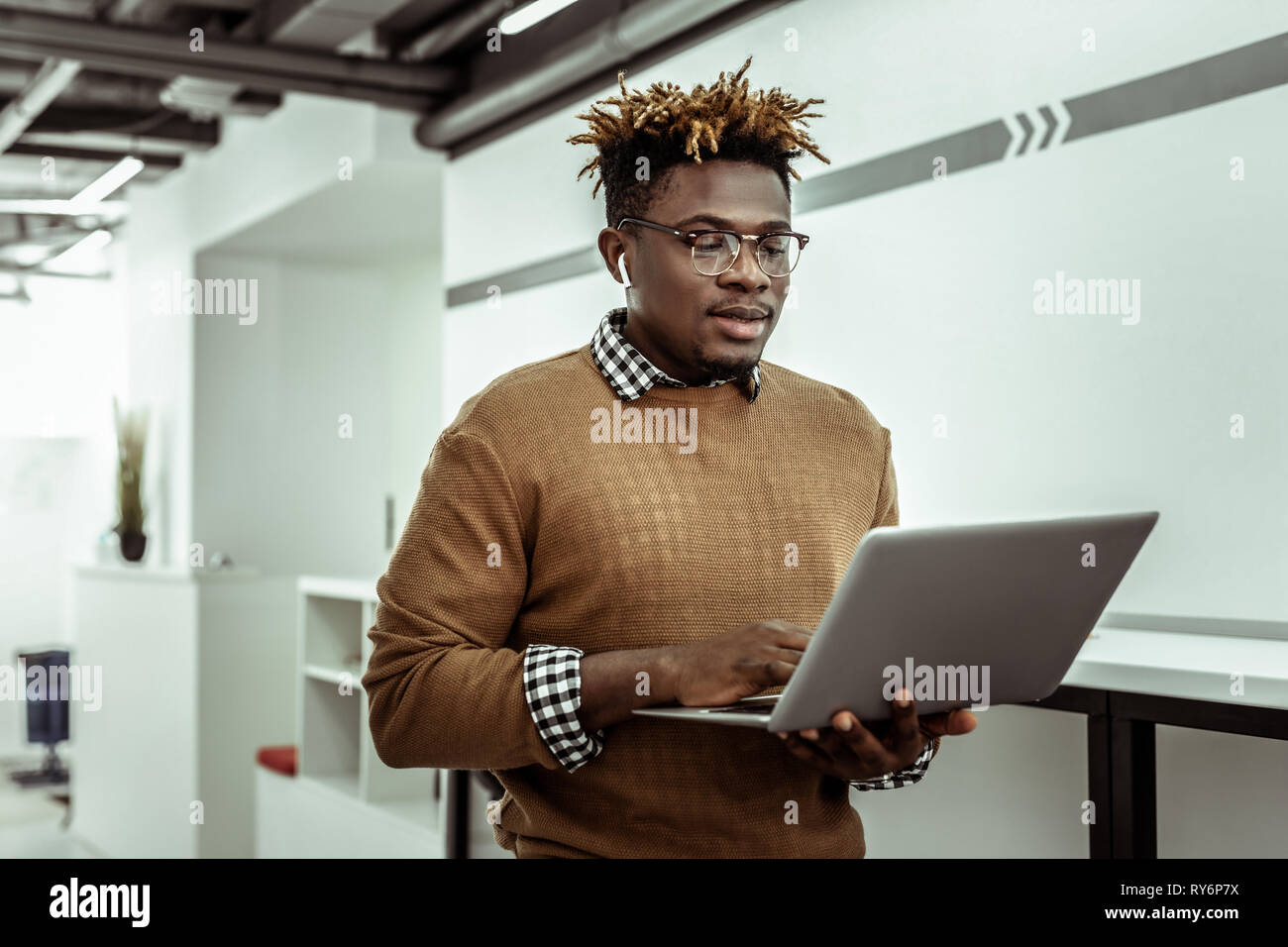 Afrikanische amerikanische Programmierer in klare Gläser holding Laptop Stockfoto