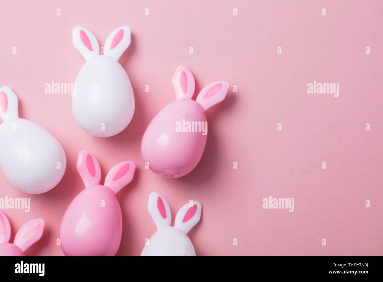 Ostereier mit Hasenohren auf einem Pastell rosa Hintergrund Stockfoto