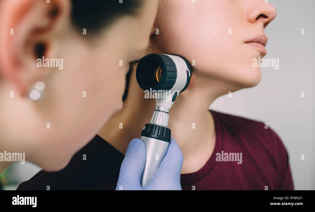 Der hautarzt Untersuchung der Haut des Patienten mittels Dermatoskop Stockfoto