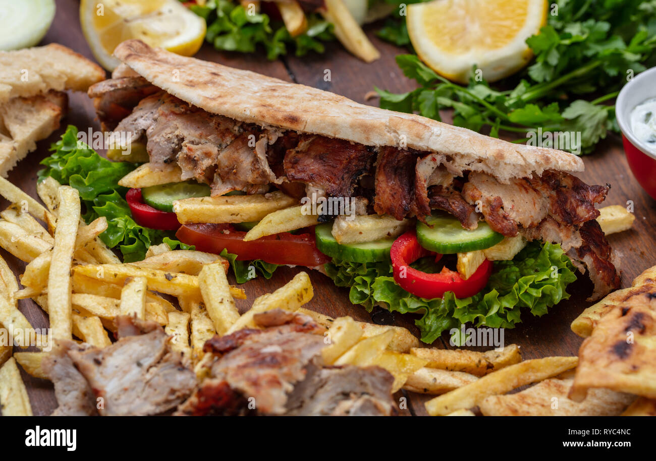 Gyros, Shawarma, take away, Street Food. Sandwich mit Fleisch auf Holztisch, Detailansicht Stockfoto