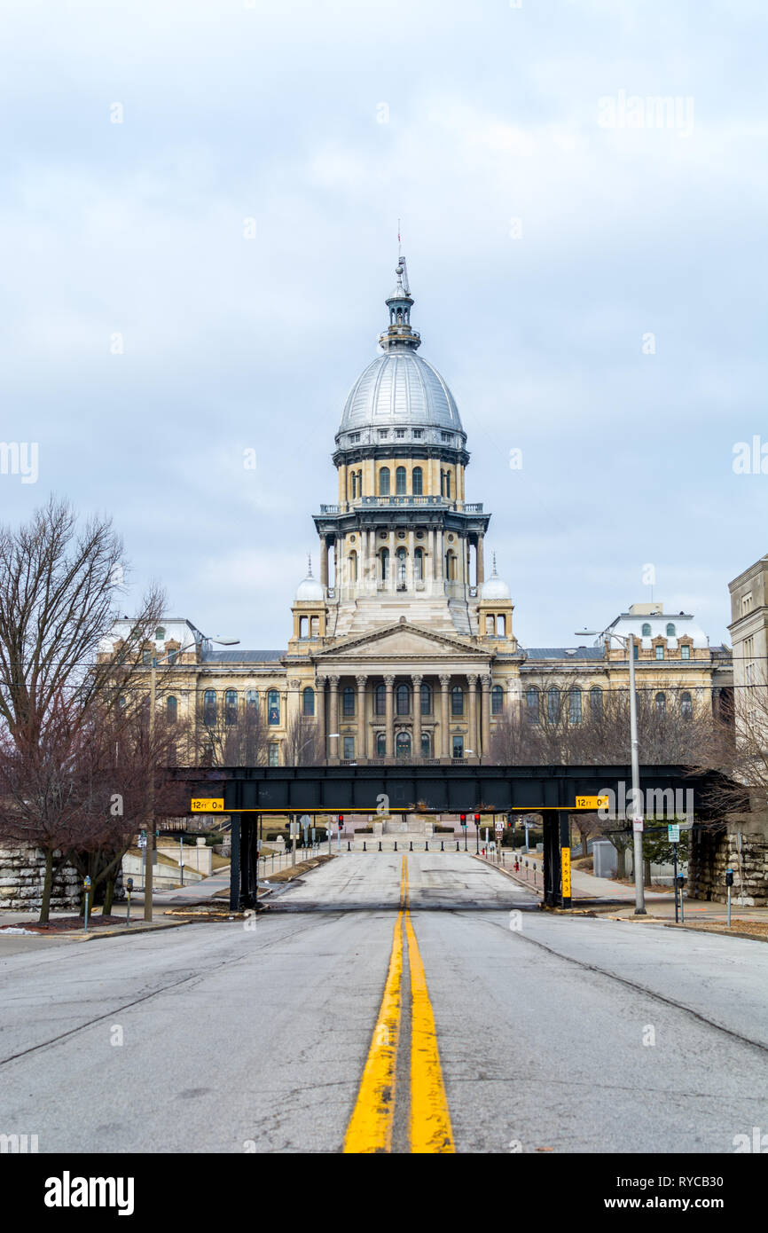 Gelbe Linien und Schlaglöcher auf der Straße auf das State Capitol Building in Springfield, Illinois. Stockfoto