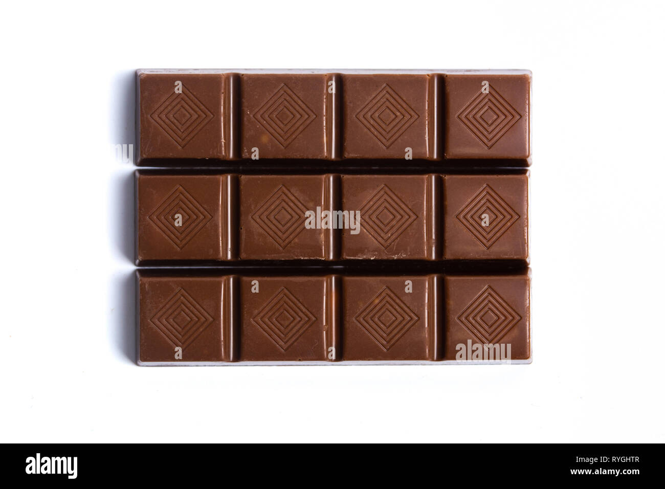 Schokolade Stück auf weißem Hintergrund Draufsicht isoliert Stockfoto