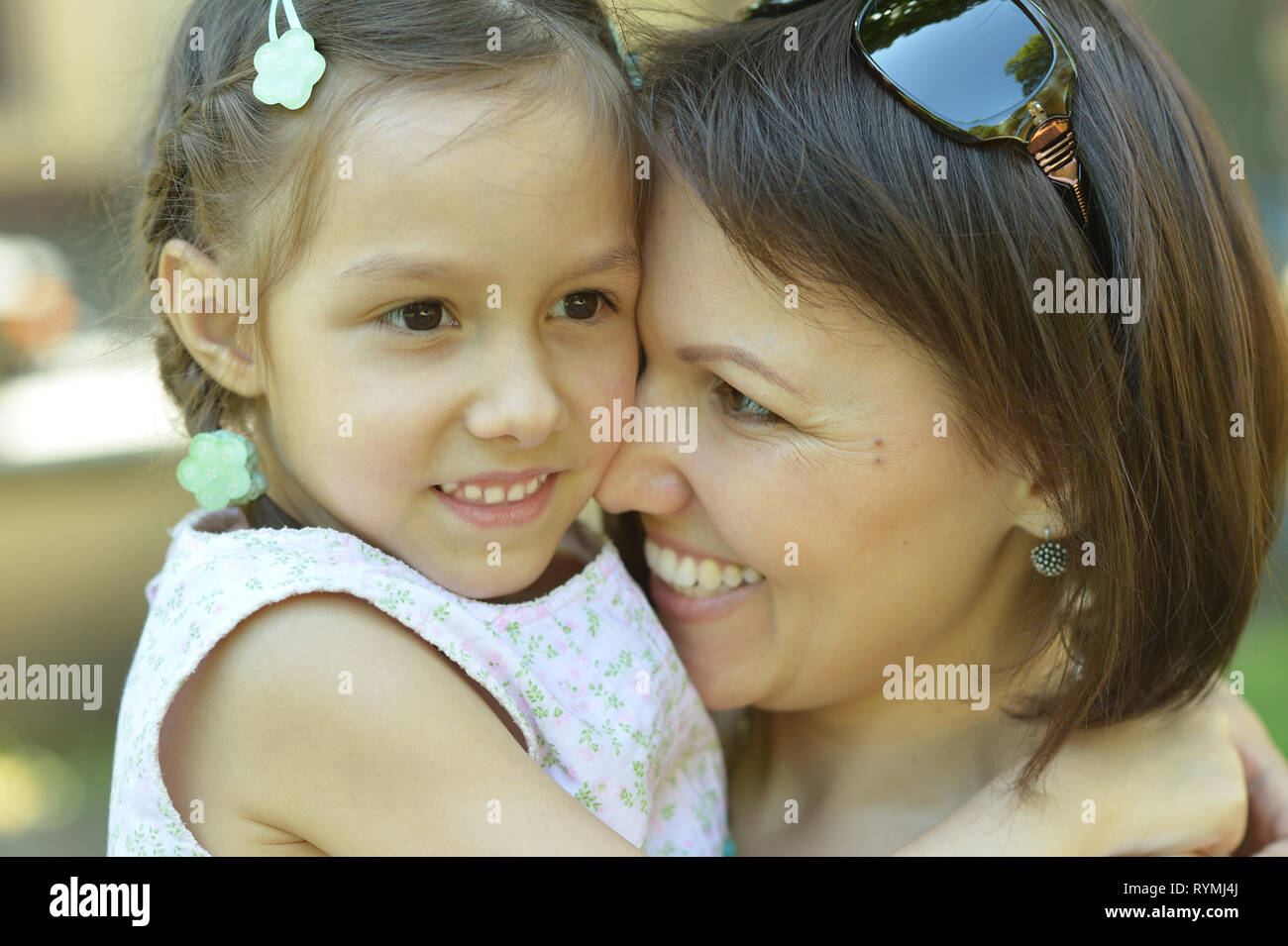 Portrait der glücklichen Mutter mit ihrer Tochter zu Fuß im Sommer Stockfoto