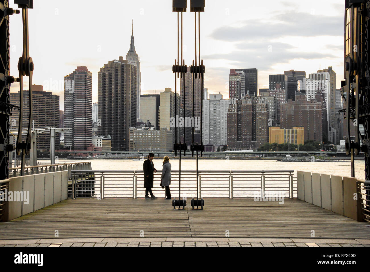 Zwei Leute an der wunderschönen Skyline von New York City aus Long Island bei Sonnenuntergang auf der Suche Stockfoto