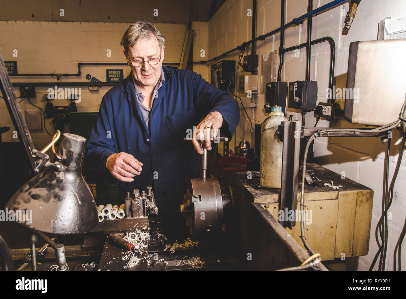 Eine qualifizierte Techniker Verschärfung ein Chuck auf einer Drehbank in einer Maschinenfabrik in Kent, Großbritannien Stockfoto