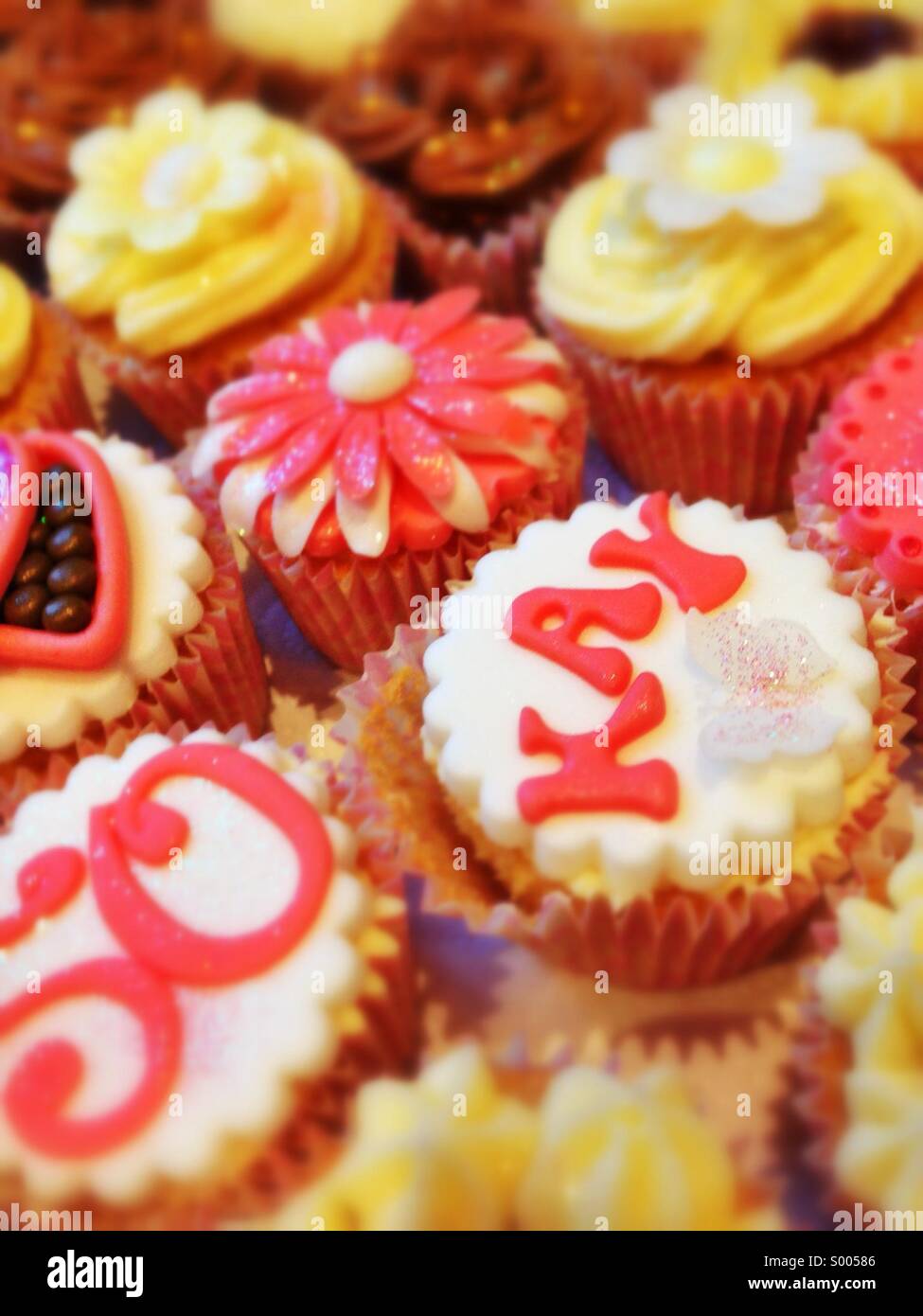 Pink and Yellow dekorierte Cupcakes für eine 50. Geburtstagsfeier: Phillip Roberts - Smartphone-aufgenommenes Stockfoto