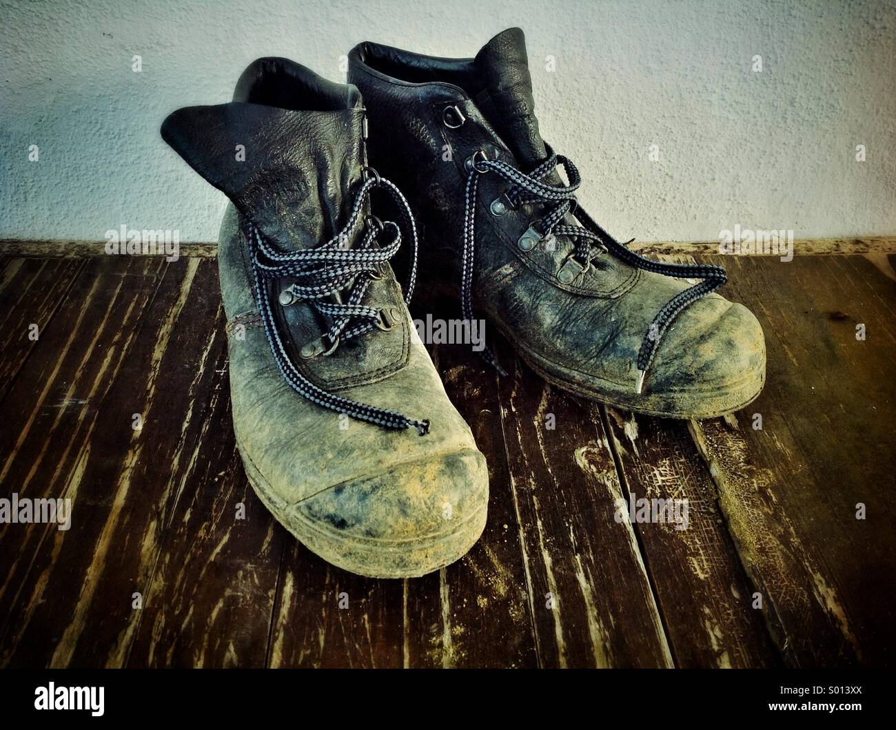 Ein abgenutztes Paar Arbeitsstiefel mit Stahlkappe. - Smartphone-aufgenommenes Stockfoto