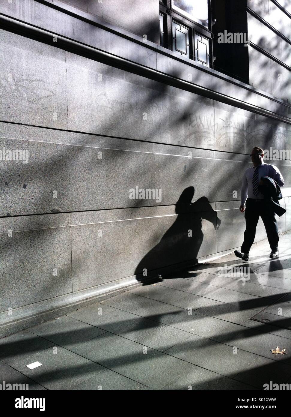 Mann zu Fuß in die Stadt-Silhouette gegen Gebäude Stockfoto