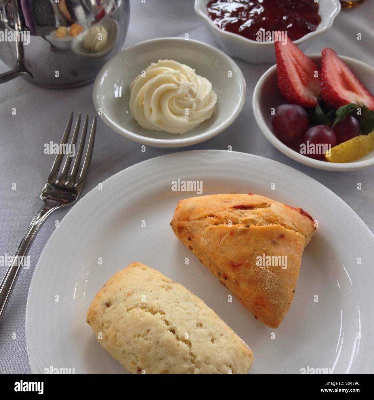 Scones mit Devonshire Cream, Marmelade und Obst beim High Tea. Stockfoto