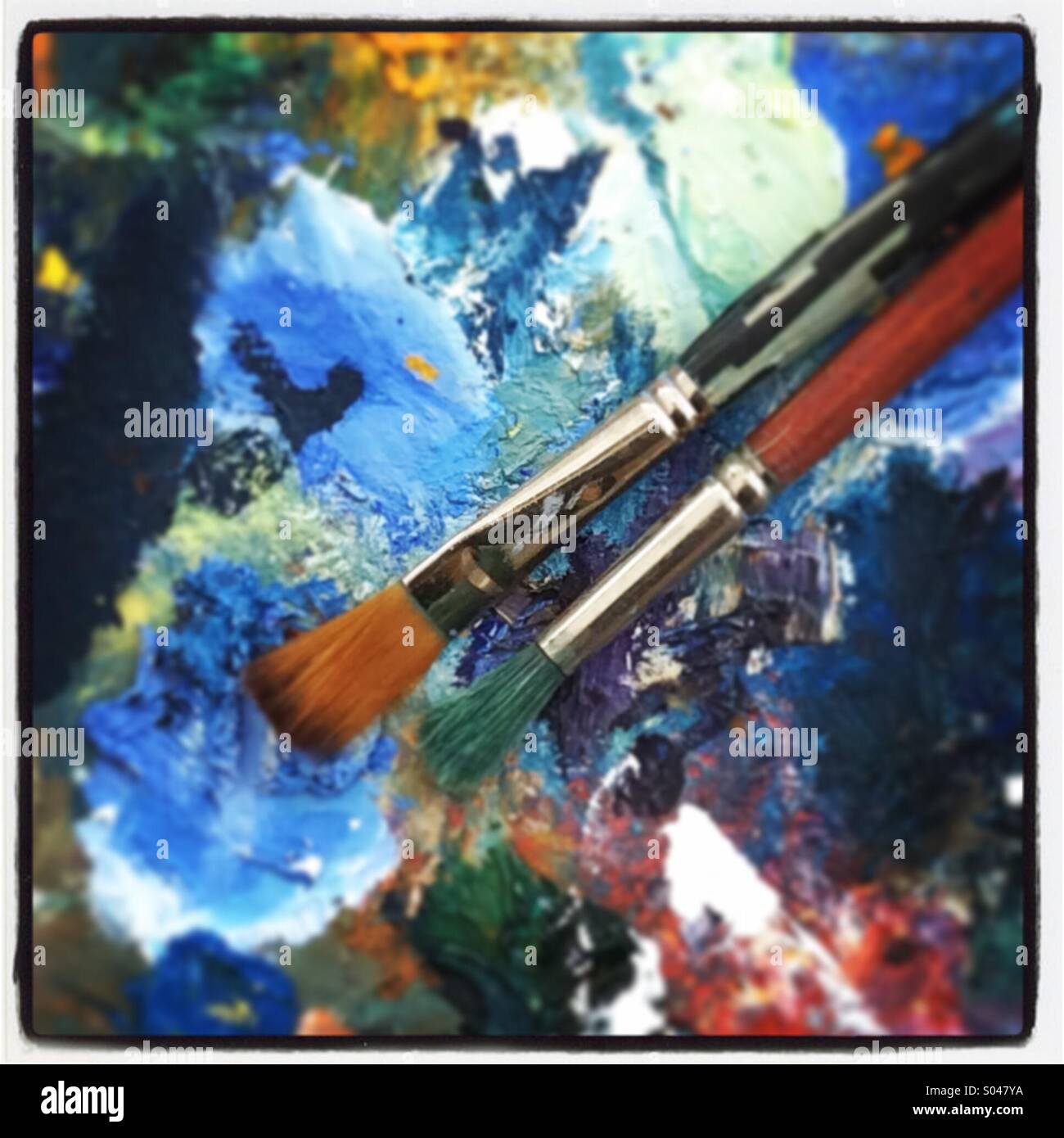 Farbenfrohe Kunst Palette mit zwei Bürsten hautnah - Smartphone-aufgenommenes Stockfoto