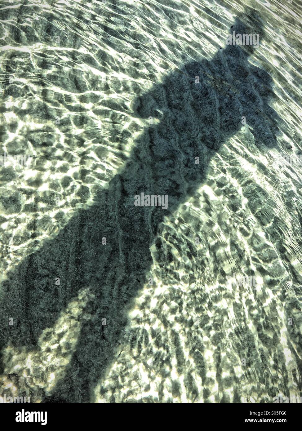 Schatten eines Mannes am Strand. Stockfoto