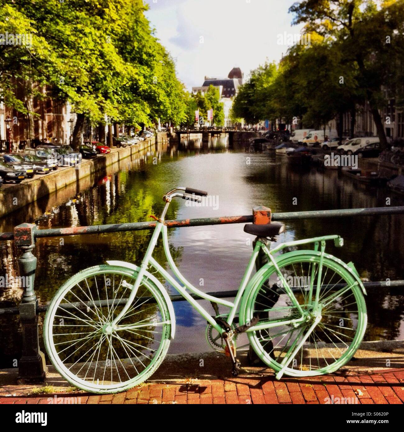 Ein Bike auf einer Brücke, über eines der vielen Grachten in Amsterdam. Die Niederlande-Europa. - Smartphone-aufgenommenes Stockfoto