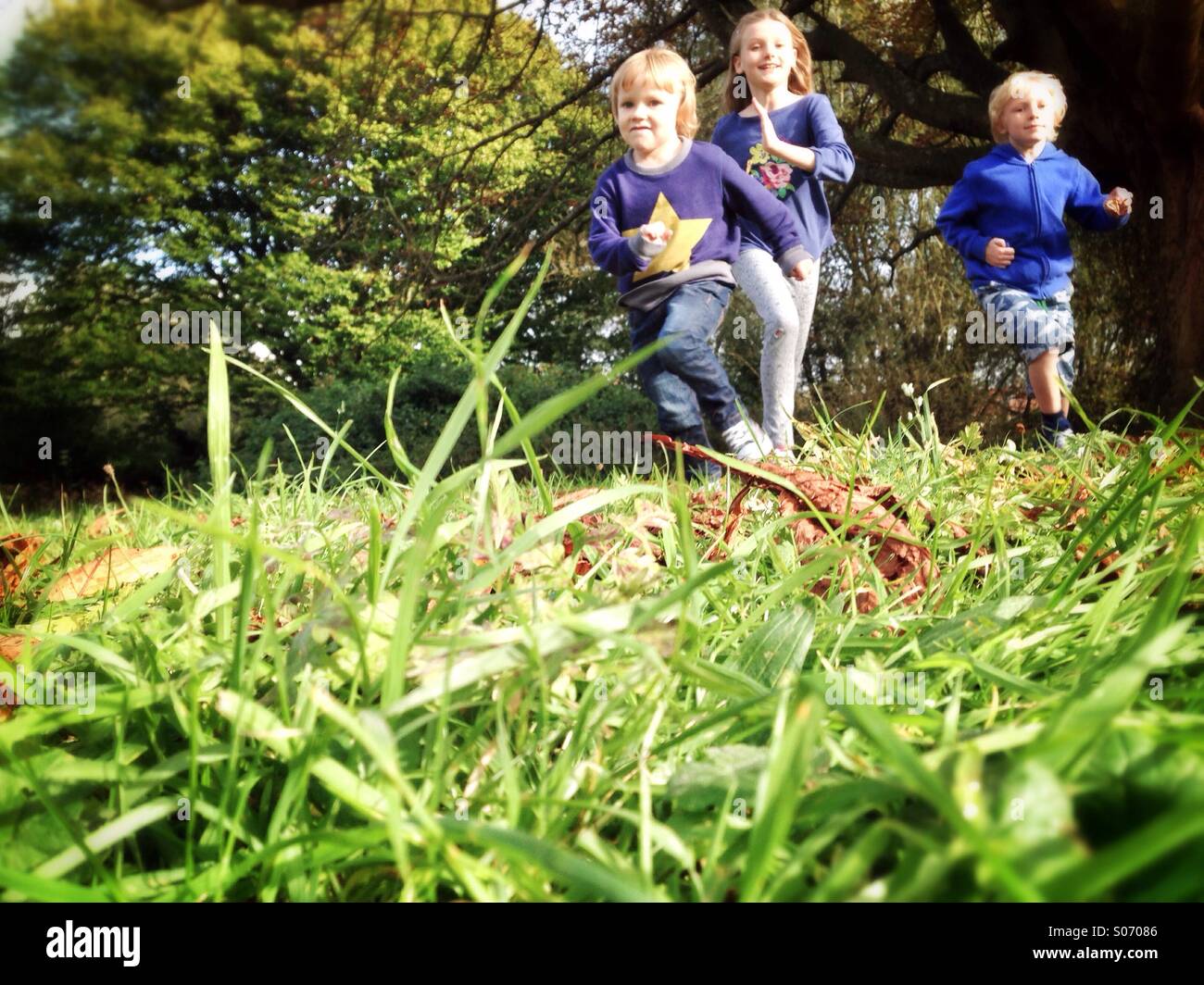 Kinder laufen über ein Feld Stockfoto