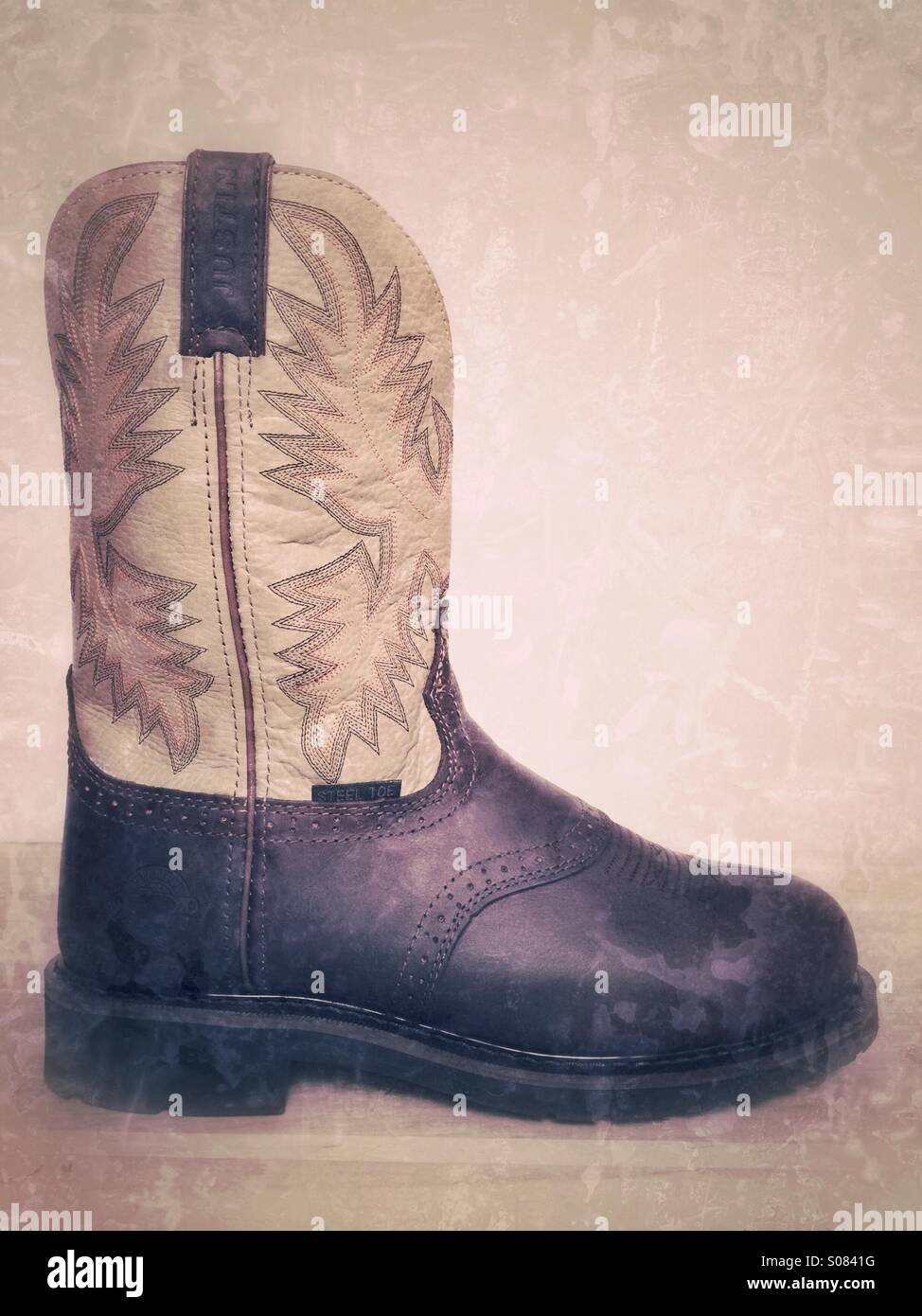 Cowboystiefel-Arbeit - Smartphone-aufgenommenes Stockfoto