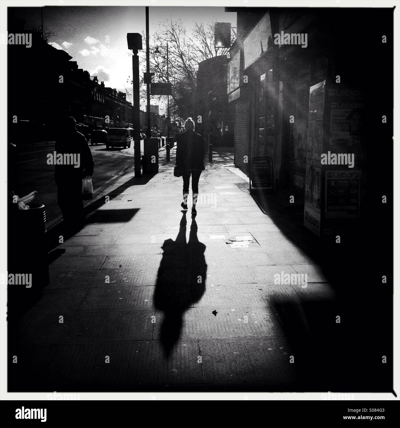 Hohen Vertrag Bild zeigt Schatten einer Person laufen auf Asphalt in London uk - Smartphone-aufgenommenes Stockfoto