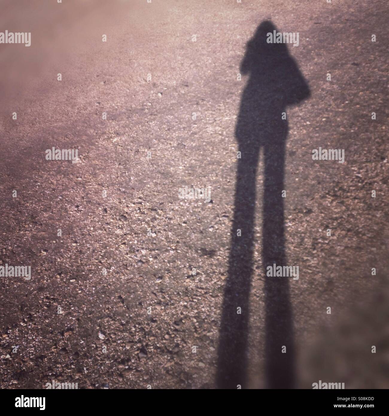 Schatten einer Person, so dass sie aussehen wie ein Riese Stockfoto