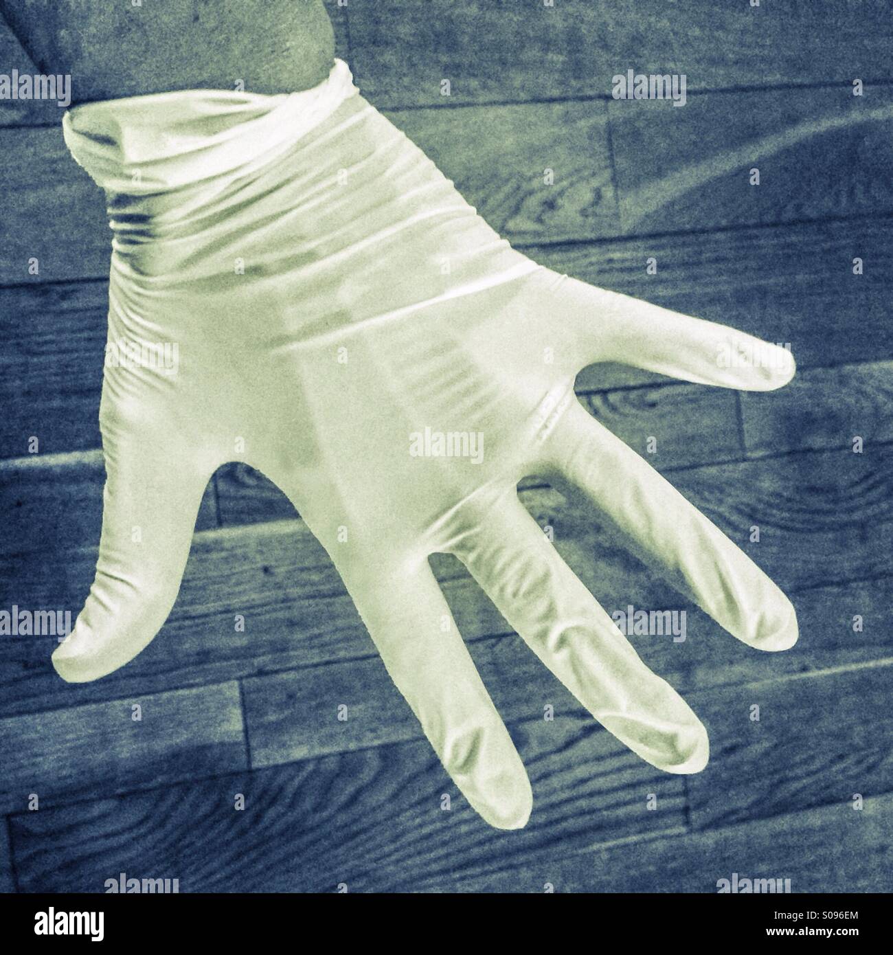 Hand und Kautschuk Handschuh Stockfoto
