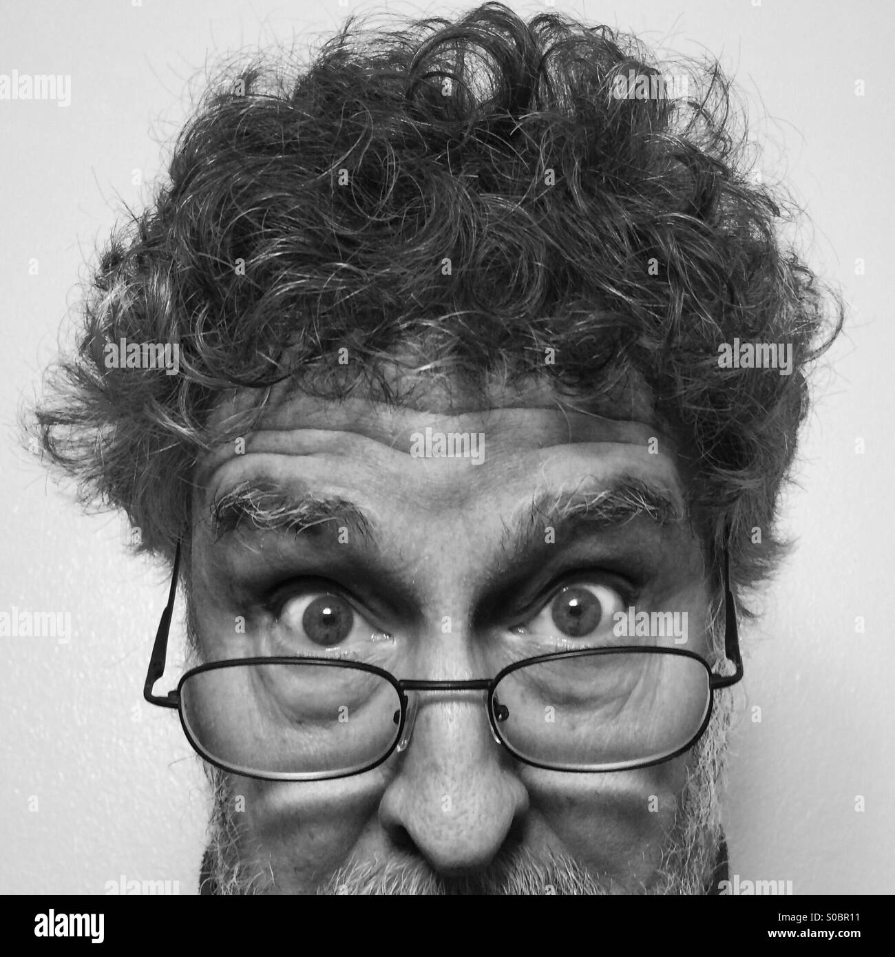 Weißer Mann, 64, bärtig, mit Brille, extreme Nahaufnahme des Gesichts Stockfoto