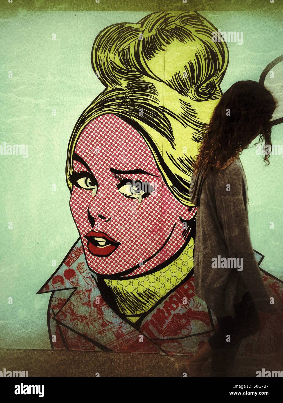 Ein Mädchen geht durch eine Kunst Wandbild an der Funk-Zone Arts District in Santa Barbara, Kalifornien - Smartphone-aufgenommenes Stockfoto