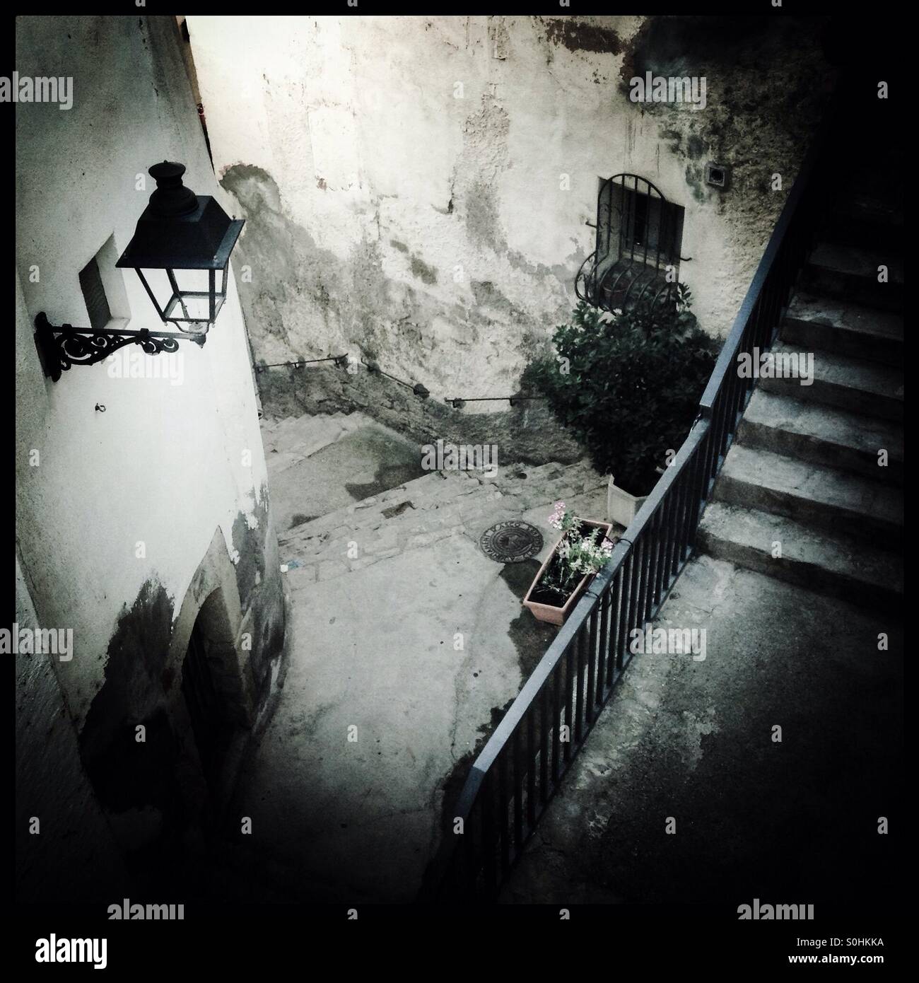 Straßenbild; Treppen und eine alte Straßenlaterne in einen Gang, Ascó, Katalonien, Spanien. - Smartphone-aufgenommenes Stockfoto