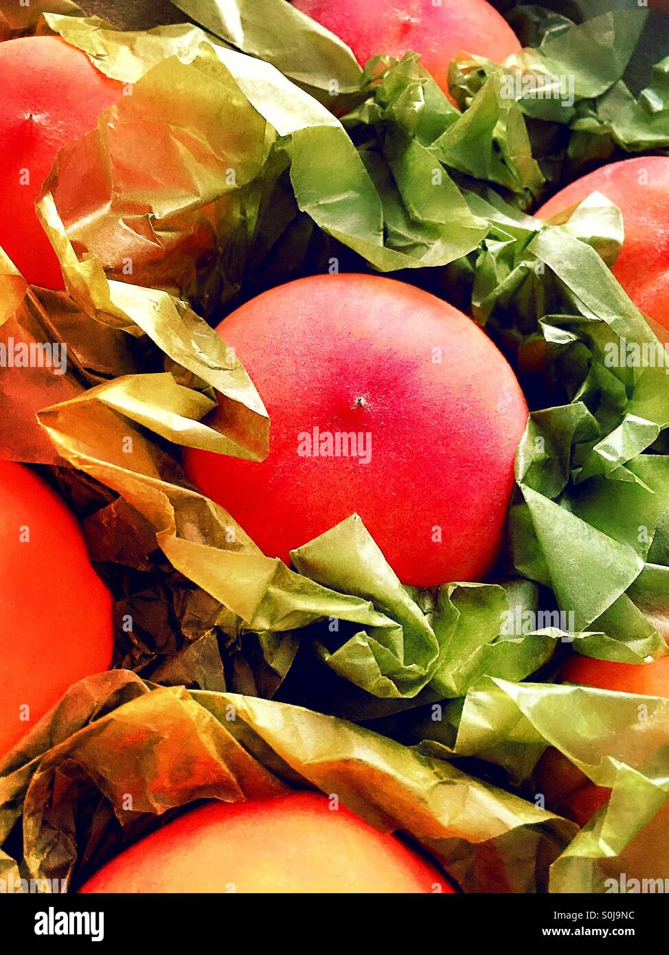 Frische reife Pfirsiche in Verpackungskasten. - Smartphone-aufgenommenes Stockfoto