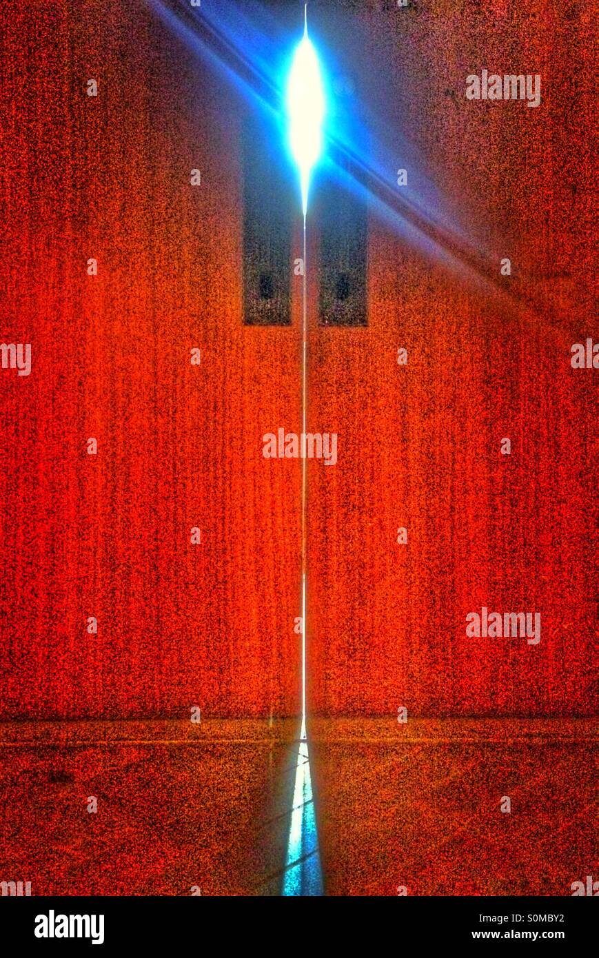 Rote Tür mit Licht spähen durch Stockfoto