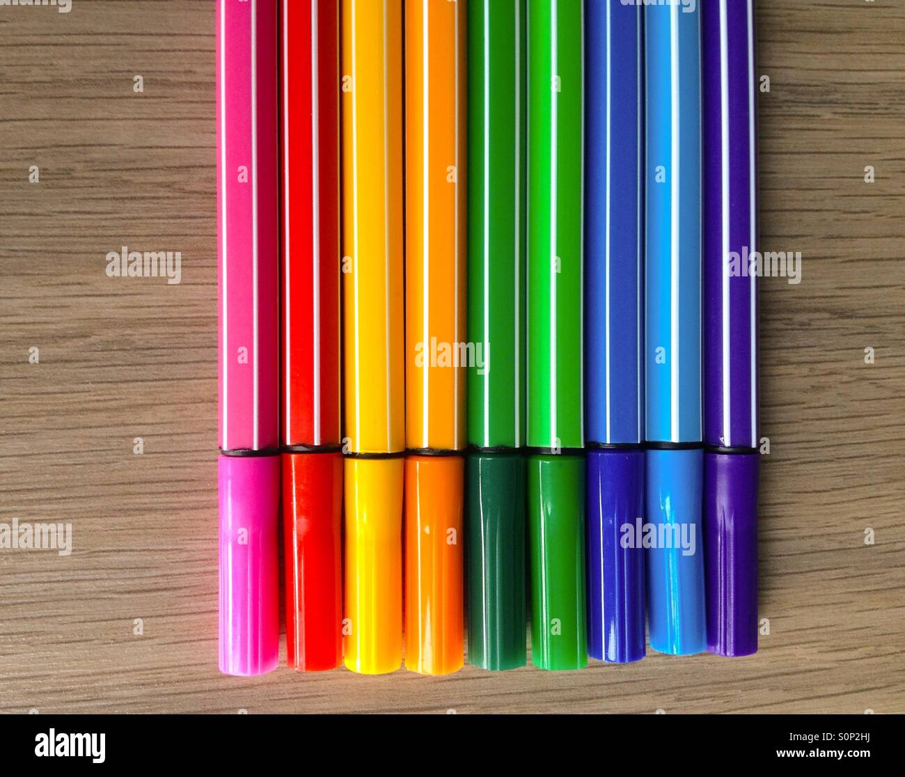 Bunte Filzstifte auf einem hölzernen Hintergrund - Smartphone-aufgenommenes Stockfoto