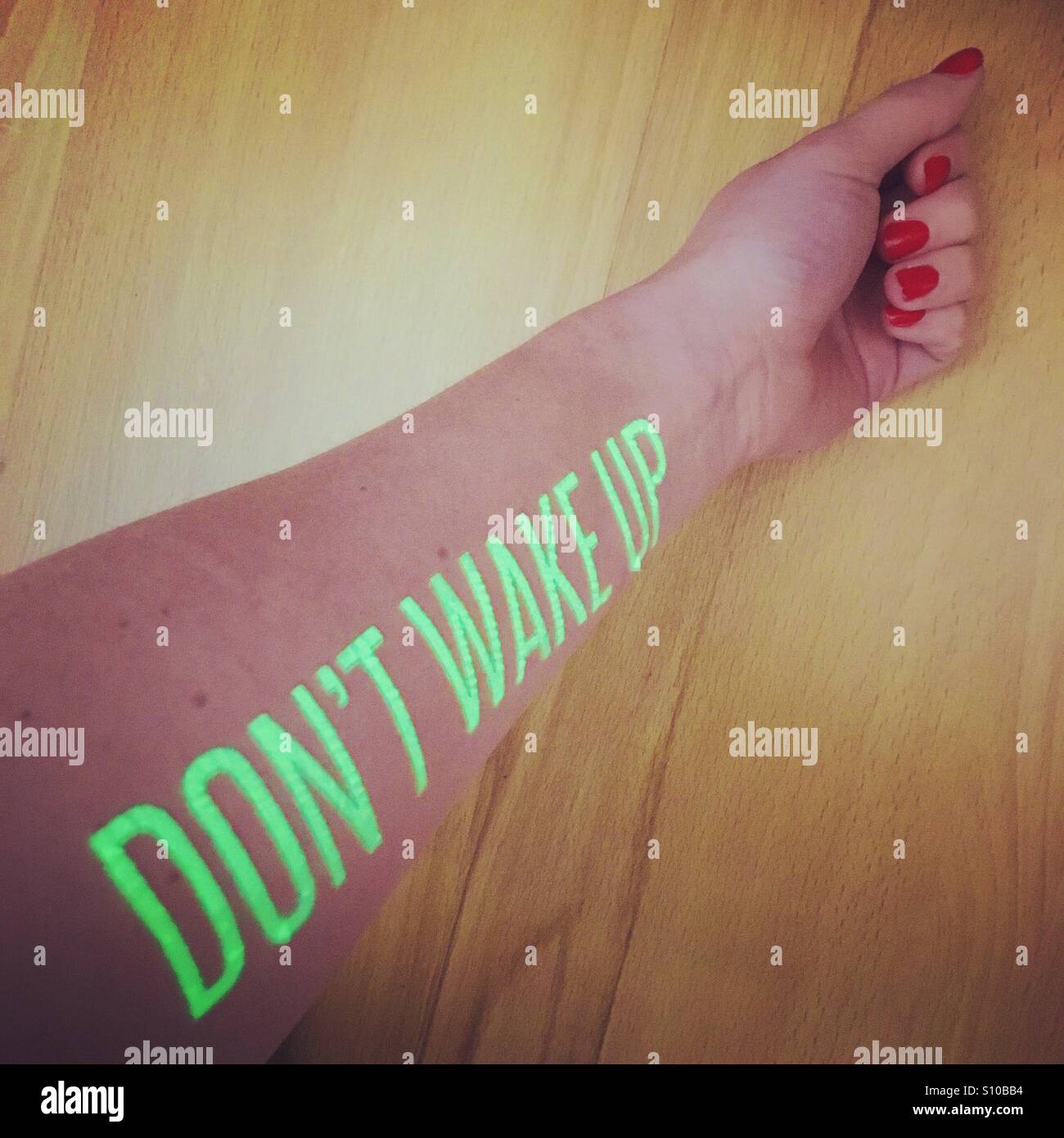 "Don ' t wake up" Glühen in der dunklen temporäre Tattoo von Secret Cinema 28 Tage später, an einem arm Stockfoto