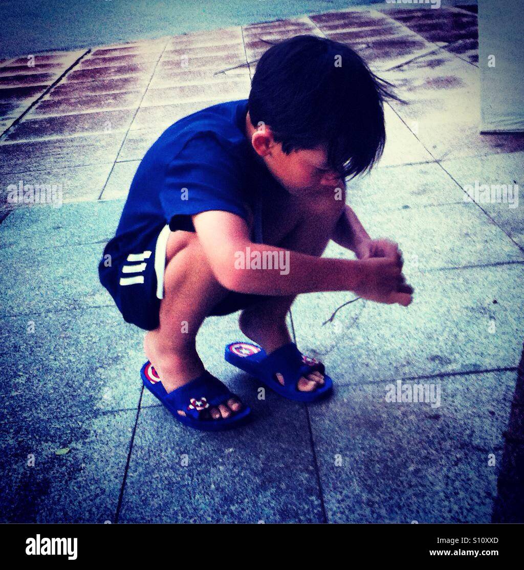 Kleiner Junge spielt auf Tle Boden Stockfoto