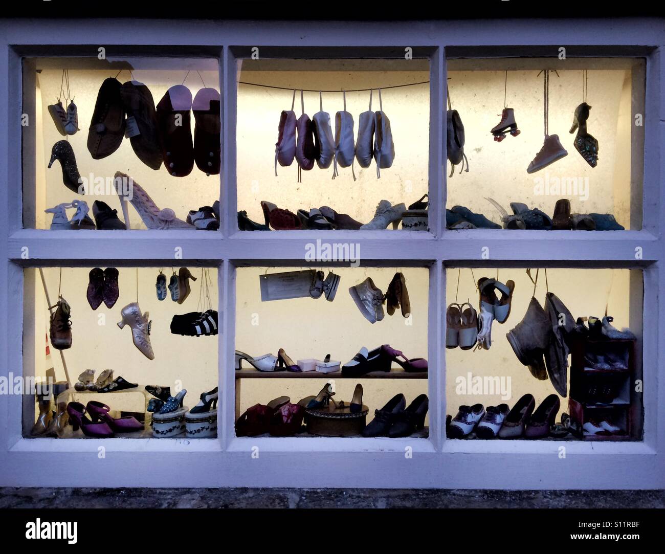 Miniatur-Schuhe in einem Schaufenster Silhouette Stockfoto