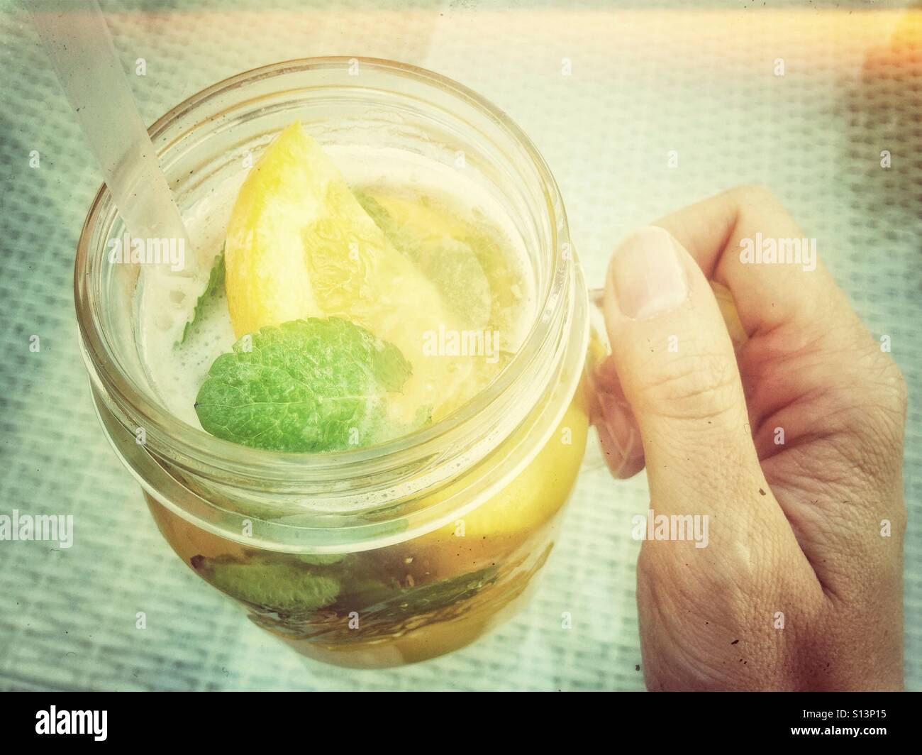 Retro-Glas Limonade cocktail in der hand - Smartphone-aufgenommenes Stockfoto