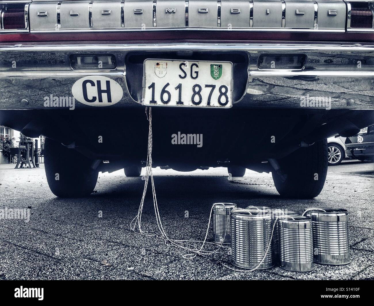 Blechdosen gebunden an der Rückseite des Oldsmobile Oldtimer - Smartphone-aufgenommenes Stockfoto