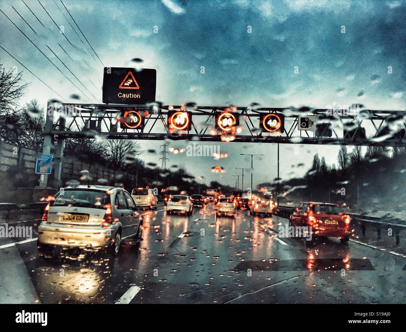 Fahren auf der M6, intelligente Motrway im Regen. Obenliegende Gantry mit Geschwindigkeitsbeschränkungen und Beratung Stockfoto