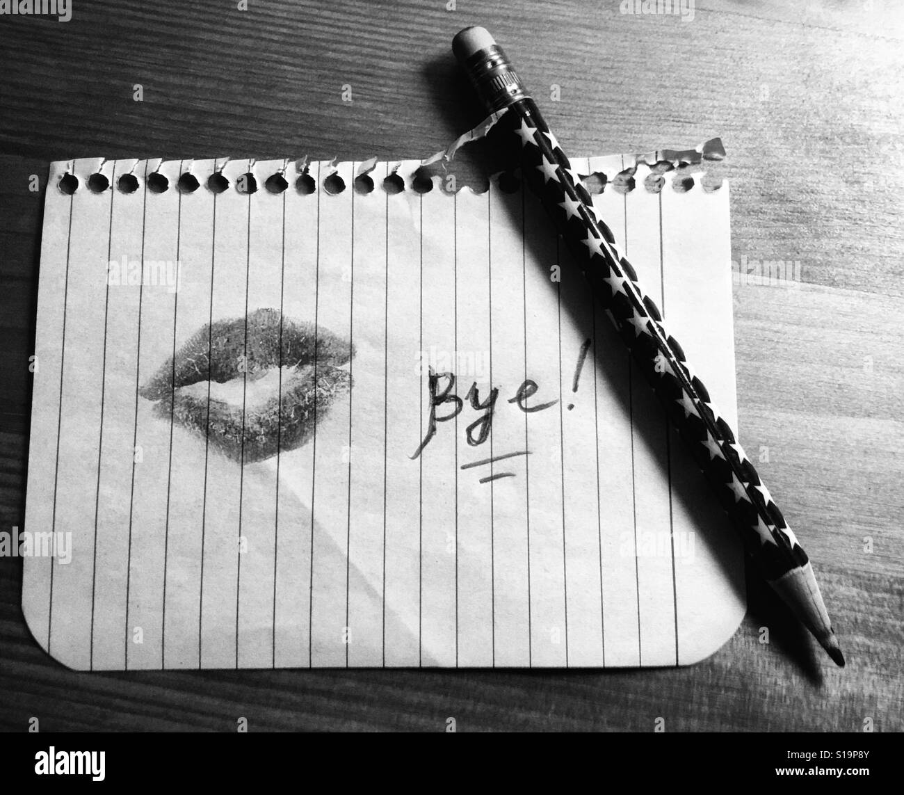 Frau Lippenstift Mark auf Blatt Papier, das Wort 'Auf Wiedersehen' dort geschrieben und einen Stift in der Nähe Stockfoto