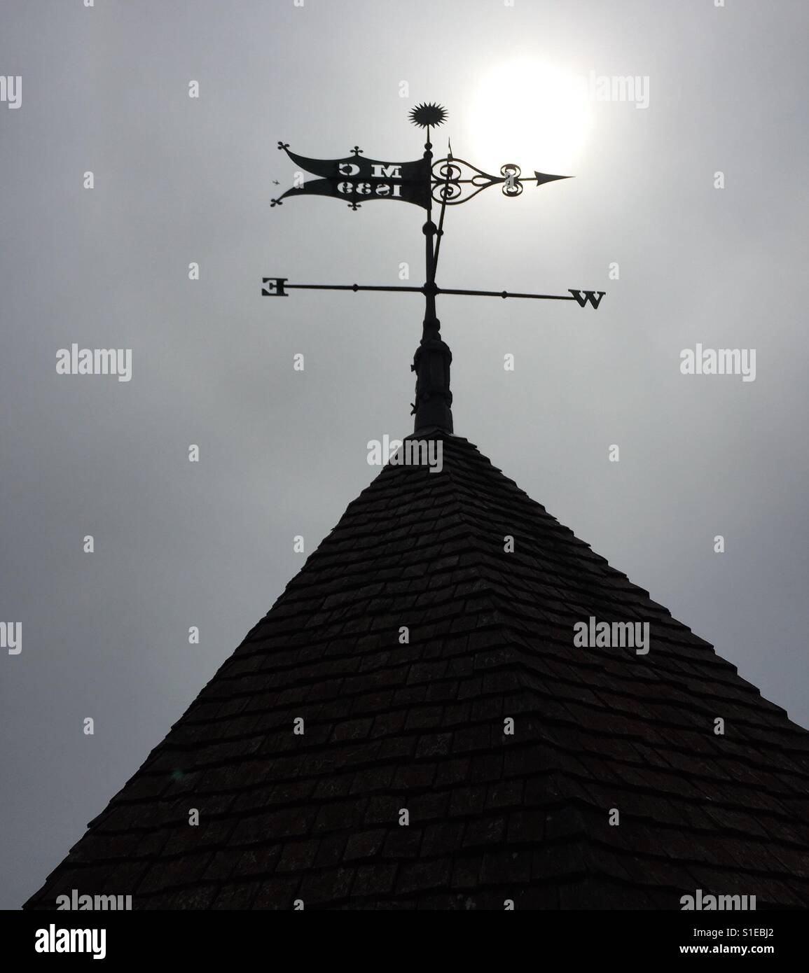 Wetterfahne Silhouette gegen die Sonne - Smartphone-aufgenommenes Stockfoto
