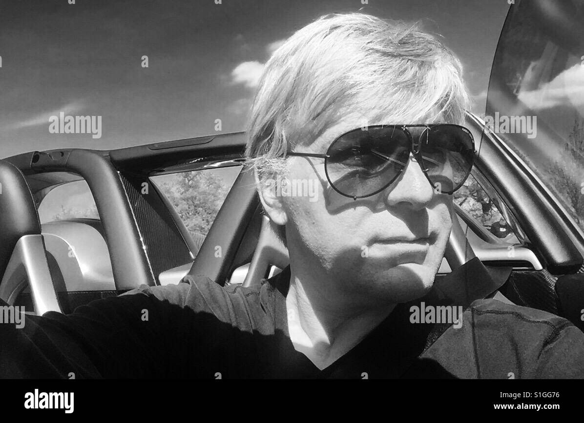 Mann im Porsche Design Sonnenbrille am Steuer eines Porsche Carrera GT  Stockfotografie - Alamy
