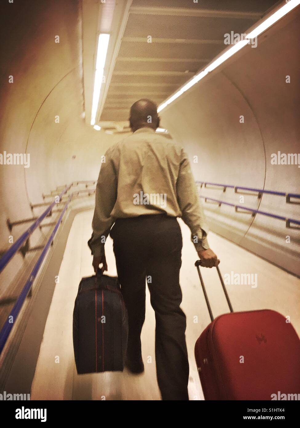 Pendler mit seinem Gepäck in u-Bahnstation in London - Smartphone-aufgenommenes Stockfoto